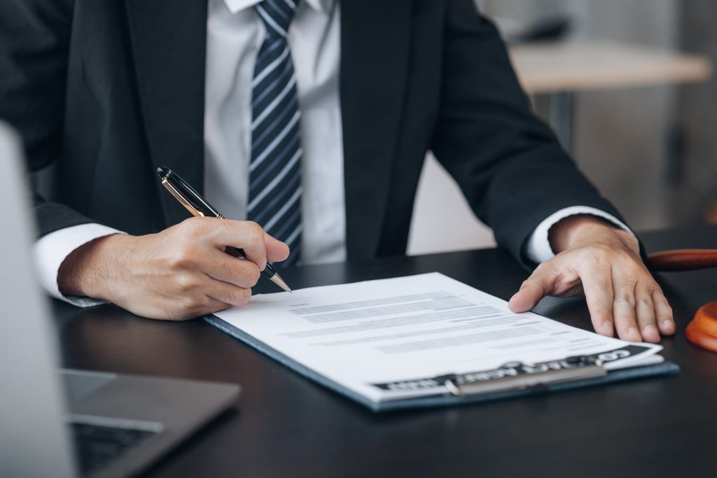 Businessman signing a contract document.