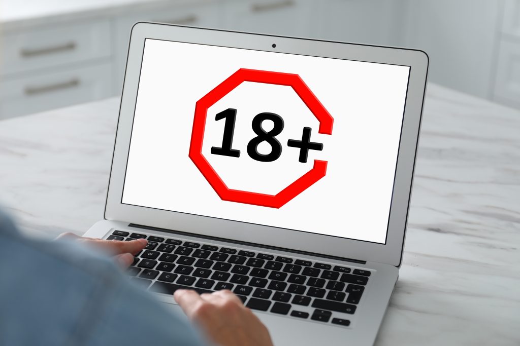 Adult content warning on laptop screen